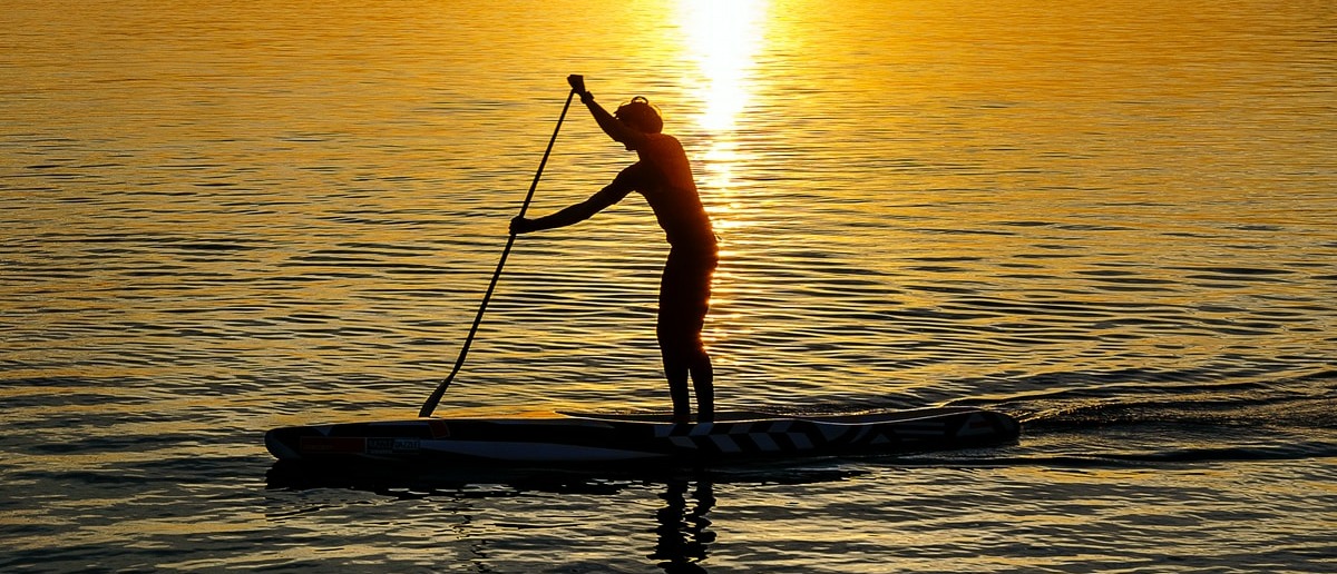 man on kayak during sunset